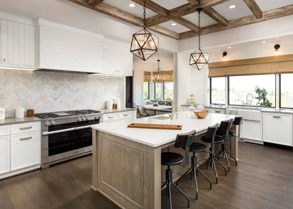 A large kitchen with a large island in the middle of it.