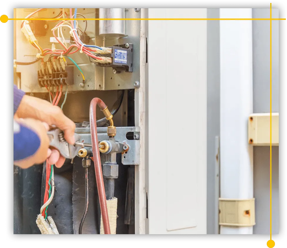 A person is working on an air conditioner with a wrench. A person is working on an air conditioner with a wrench.