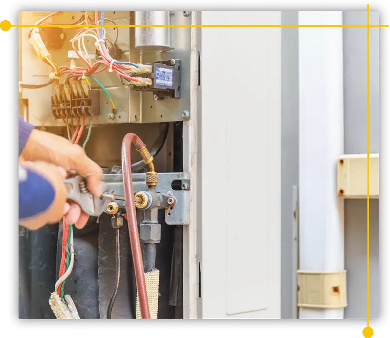 A person is working on an air conditioner with a wrench. A person is working on an air conditioner with a wrench.