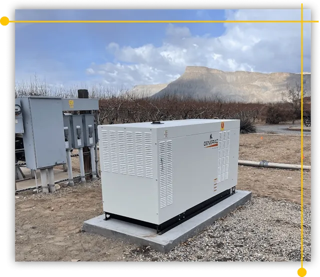 A large white generator is sitting in the middle of a dirt field. A large white generator is sitting in the middle of a dirt field.